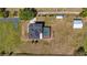 Aerial shot showcases the property layout with pool and outbuildings at 21046 County Road 33, Groveland, FL 34736