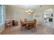 Cozy dining area with round wooden table, chairs, and view into the kitchen at 21046 County Road 33, Groveland, FL 34736