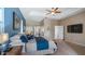 Spacious main bedroom with a tray ceiling, ceiling fan, and door to the ensuite bathroom at 21046 County Road 33, Groveland, FL 34736