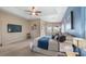 Main bedroom with a tray ceiling, ceiling fan, sitting area and view of the lanai at 21046 County Road 33, Groveland, FL 34736