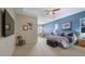 Spacious main bedroom featuring a tray ceiling, sitting area, and stylish furniture at 21046 County Road 33, Groveland, FL 34736