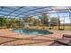 Beautiful, screened-in pool with brick patio and view of the yard at 21046 County Road 33, Groveland, FL 34736