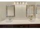 Bathroom with double vanity and elegant framed mirrors at 2205 Stonebridge Way, Clermont, FL 34711