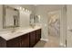 Bathroom featuring double sinks, marble shower, and updated fixtures at 2205 Stonebridge Way, Clermont, FL 34711