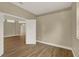 Neutral-toned bedroom featuring hardwood floors and a view into the hallway at 2205 Stonebridge Way, Clermont, FL 34711