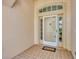 Inviting entryway with decorative brick flooring and a charming front door at 2205 Stonebridge Way, Clermont, FL 34711