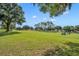 Expansive golf course with green grass, trees, and golf carts at 2205 Stonebridge Way, Clermont, FL 34711