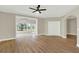 Inviting living room featuring hardwood floors, ceiling fan, and archway to the backyard at 2205 Stonebridge Way, Clermont, FL 34711