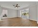 Bright living room with ceiling fan, hardwood floors, and views to the backyard at 2205 Stonebridge Way, Clermont, FL 34711