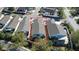 Aerial view of home featuring mature trees, backyard screened patio, and white privacy fence at 2238 Pilar Pl, The Villages, FL 32162