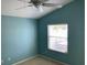 Bright bedroom with a ceiling fan and a window overlooking outdoor scenery at 2238 Pilar Pl, The Villages, FL 32162