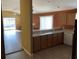 Bright kitchen showcasing tile flooring, light countertops, breakfast bar, and views of the living room at 2238 Pilar Pl, The Villages, FL 32162