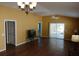 This living room features wood floors, ceiling fan, and sliding glass doors at 2238 Pilar Pl, The Villages, FL 32162