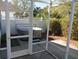 This screened-in patio features a hot tub and lush greenery at 2238 Pilar Pl, The Villages, FL 32162