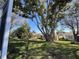 Large tree shading the lawn of this well maintained single Gathering home in a manicured community at 24614 Stillridge Ct, Leesburg, FL 34748