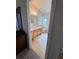 Neutral bathroom features tile flooring, wooden vanity with a countertop, and a window for natural light at 24614 Stillridge Ct, Leesburg, FL 34748