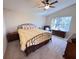 Bright bedroom featuring a ceiling fan, vaulted ceiling, and a cozy decor at 24614 Stillridge Ct, Leesburg, FL 34748