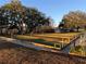 Full view of community bocce ball court offers shaded benches on a sunny day at 24614 Stillridge Ct, Leesburg, FL 34748