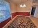 Dining room with tile floors, chandelier, and large windows at 24614 Stillridge Ct, Leesburg, FL 34748