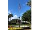 Scenic view of a tiered fountain, set against a blue sky and waving American flag at 24614 Stillridge Ct, Leesburg, FL 34748