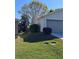 A single Gathering house with a gray garage door and green lawn at 24614 Stillridge Ct, Leesburg, FL 34748