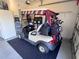 Golf cart parked inside the spacious garage, offering convenient storage and easy access for golf enthusiasts at 24614 Stillridge Ct, Leesburg, FL 34748