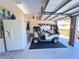 Garage view featuring a golf cart, refrigerator, and ample space, enhancing convenience and functionality at 24614 Stillridge Ct, Leesburg, FL 34748