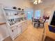 Light-filled eat-in kitchen with pool view and a white hutch at 24614 Stillridge Ct, Leesburg, FL 34748