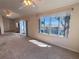 Spacious living room boasts carpet flooring, large windows that provide natural lighting, and neutral paint at 24614 Stillridge Ct, Leesburg, FL 34748