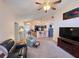 Cozy living room showcasing a neutral color palette and view to kitchen at 24614 Stillridge Ct, Leesburg, FL 34748