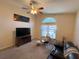 Comfortable living room with cozy seating and a vaulted window at 24614 Stillridge Ct, Leesburg, FL 34748