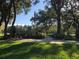 Memorial site with flags, manicured lawn, and shaded trees at 24614 Stillridge Ct, Leesburg, FL 34748