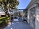 View of the outdoor dining on the screened patio featuring an exterior door to the home at 24614 Stillridge Ct, Leesburg, FL 34748