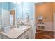 Bathroom with neutral vanity and view to another room, wood-look flooring at 2602 Young Ln, The Villages, FL 32163