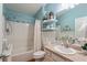Bathroom boasts updated vanity and shower with blue walls and decor at 2602 Young Ln, The Villages, FL 32163