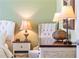 Bedroom with accent chair and decorative lamps at 2602 Young Ln, The Villages, FL 32163
