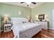 Comfortable bedroom with plush bedding and a calming green color scheme at 2602 Young Ln, The Villages, FL 32163