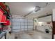 Spacious two car garage with white cabinets and shelving for storage at 2602 Young Ln, The Villages, FL 32163