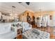 Open concept living room flows to dining area and kitchen with hardwood floors at 2602 Young Ln, The Villages, FL 32163