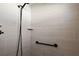 A modern bathroom featuring a tiled shower with black hardware and a built-in shelf at 2919 Monument Way, The Villages, FL 32163