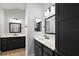 Modern bathroom with dual vanities, stylish mirrors, and sleek fixtures, offering a clean and functional design at 2919 Monument Way, The Villages, FL 32163