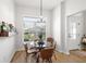 Cozy breakfast nook with a glass-top table, seating for four, and natural light from the adjacent window at 2919 Monument Way, The Villages, FL 32163