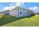 Charming home with blue exterior, green lawn, and well-maintained landscaping under a bright sky at 2919 Monument Way, The Villages, FL 32163