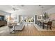 Bright and airy living room with modern decor, wood floors, and sliding doors leading to an outdoor space at 2919 Monument Way, The Villages, FL 32163