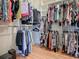 Organized walk-in closet with ample hanging space and shelving for clothes and accessories at 2922 Rain Lily Loop, The Villages, FL 32163