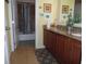 Bathroom featuring granite countertops, a double sink, and a separate toilet area at 31715 Parkdale Dr, Leesburg, FL 34748