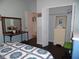 Bright bedroom with a bed, side table, chest of drawers, and hardwood floors at 31715 Parkdale Dr, Leesburg, FL 34748