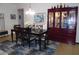 Elegant dining room with a dark wood table, china cabinet and stylish area rug at 31715 Parkdale Dr, Leesburg, FL 34748