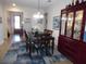 Elegant dining room with a dark wood table, china cabinet and stylish area rug at 31715 Parkdale Dr, Leesburg, FL 34748