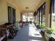 Long, enclosed porch offers ample space for relaxation and plant display, and protection from the elements at 31715 Parkdale Dr, Leesburg, FL 34748